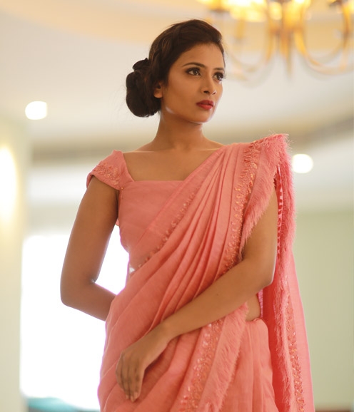 Pinkish Peach Linen Saree with feather highlights.
