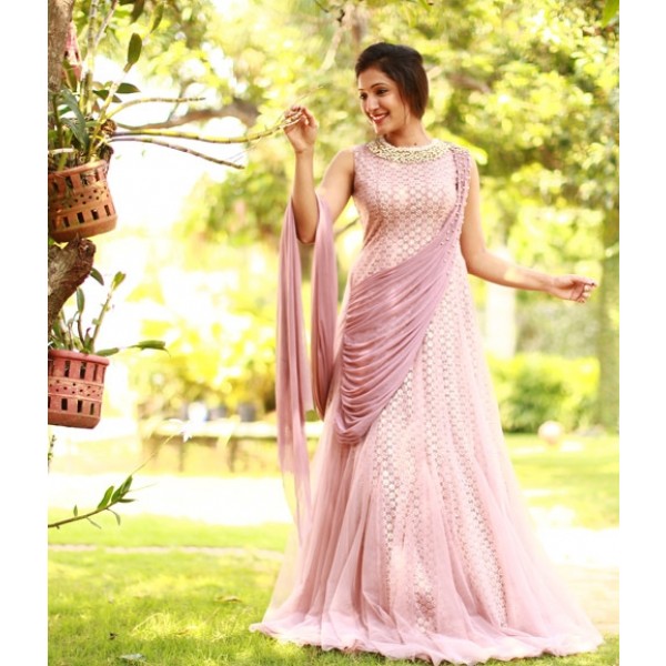 Photo of A dark pink saree gown with an embellished bodice.